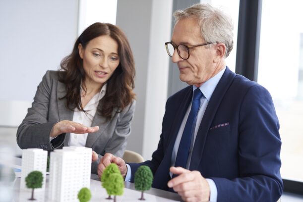 Business couple over architectural model